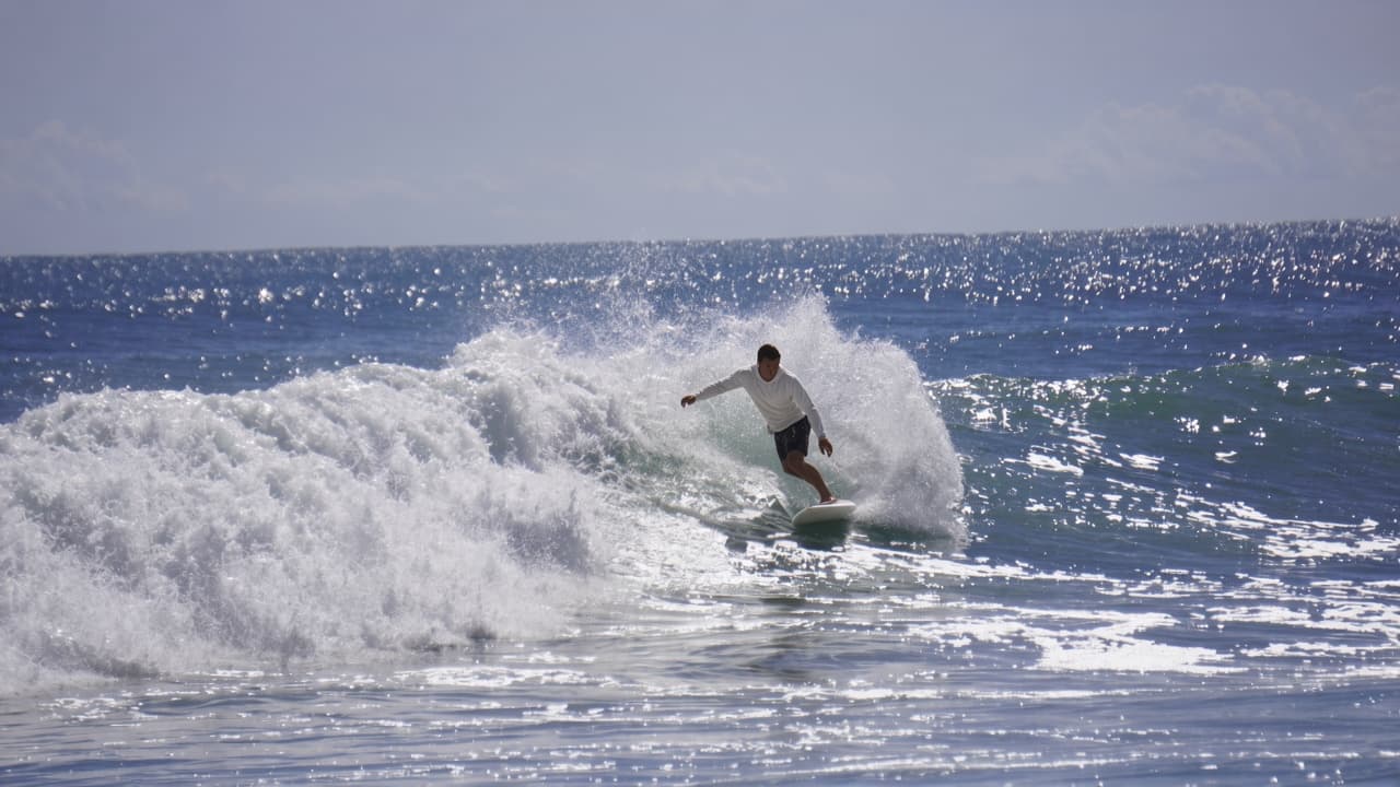 Surfing a Melbourne Beach wave in the Twin Fin sun hoodie