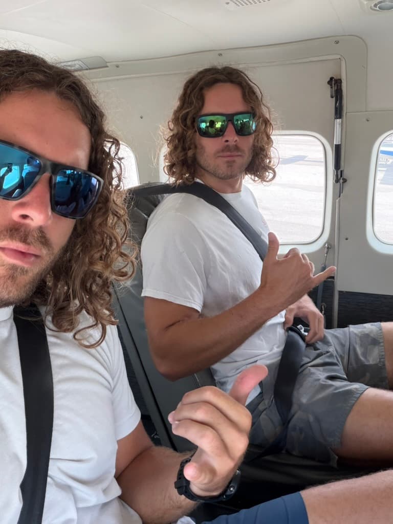 Twin brothers on a small plane, flying home